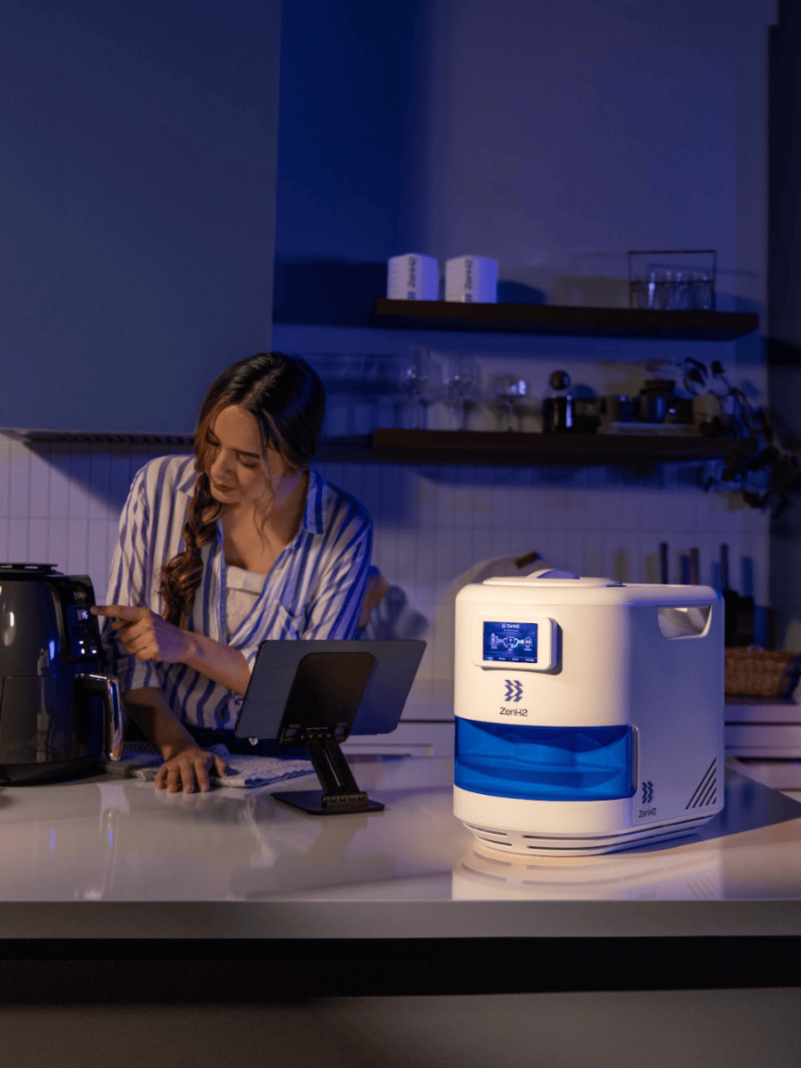The ZENH2 portable generator, a white and blue device with a glowing screen, sitting on a kitchen counter